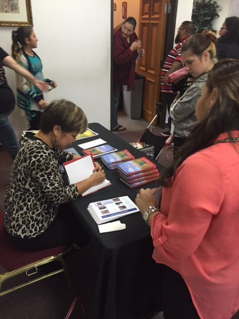 Susie signing books for readers