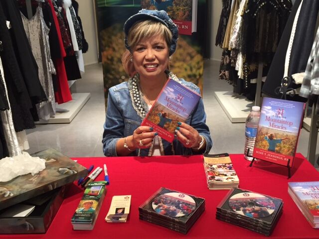 Susie greeting a reader at a book signing