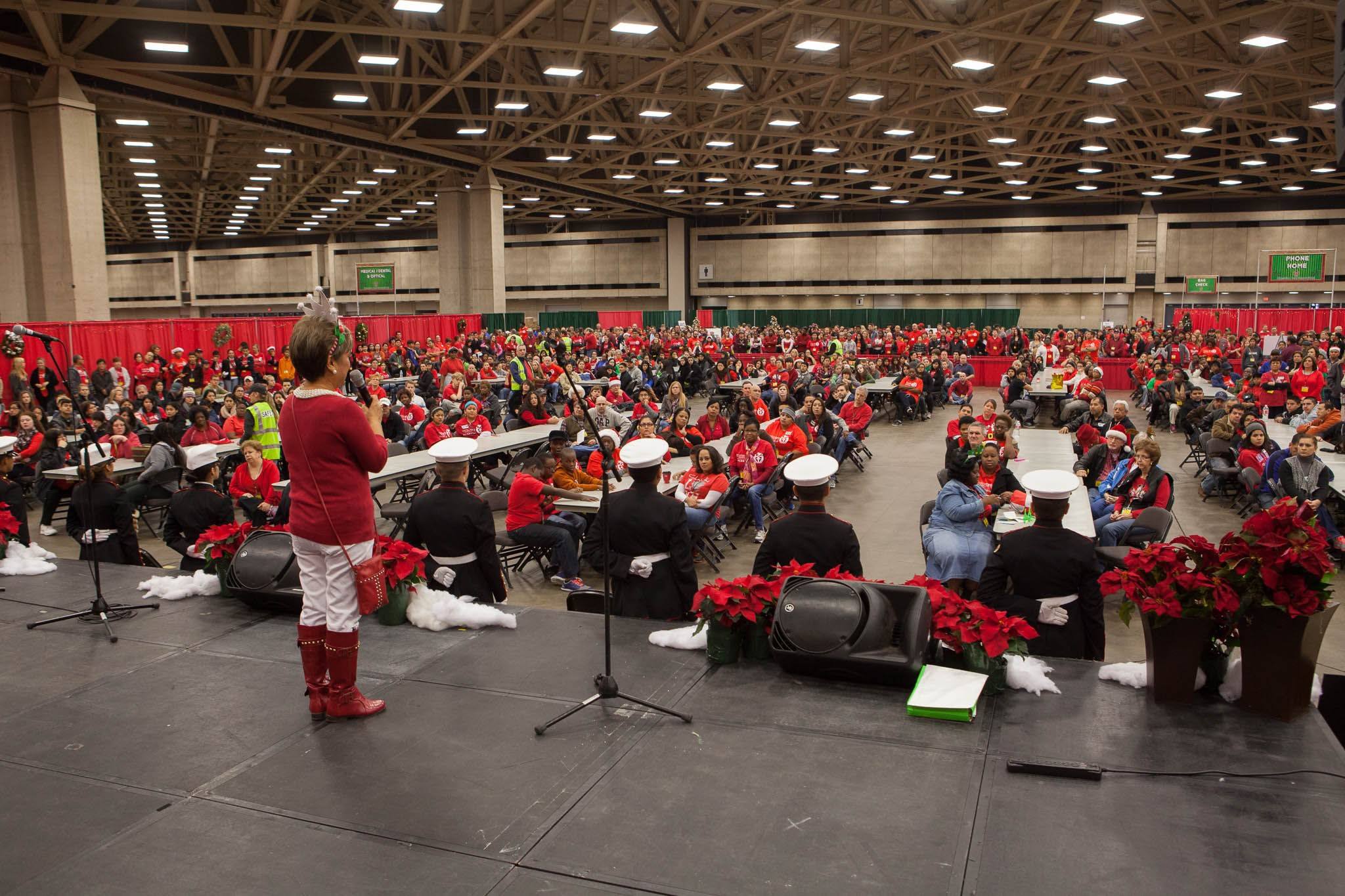 Susie speaking to a full convention hall at Operation Care Christmas Gift