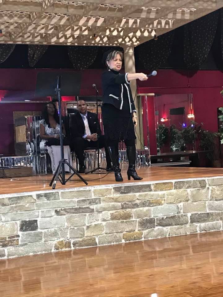 Speaking on stage black dress suit
